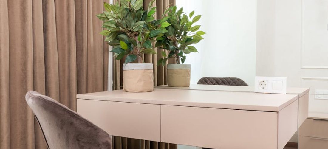 A cozy corner of a room with a yoga mat, a plant, and soft lighting.